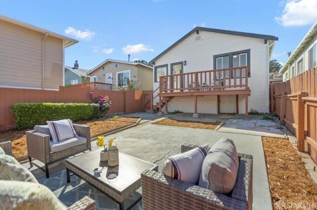 back of property with a wooden deck and a patio