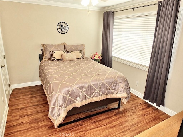 bedroom with wood-type flooring and ornamental molding