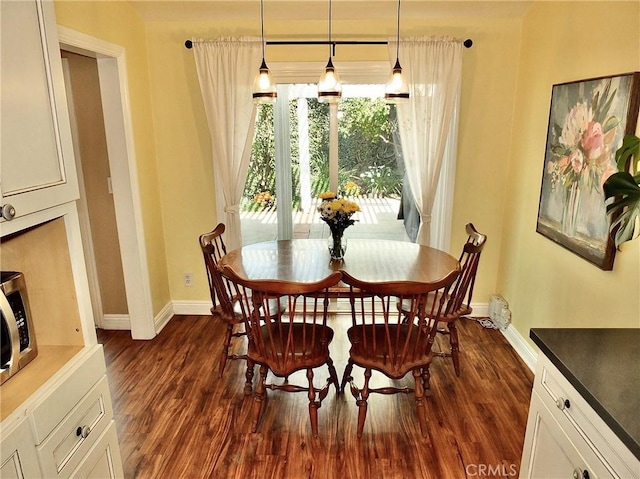 dining area with dark hardwood / wood-style floors