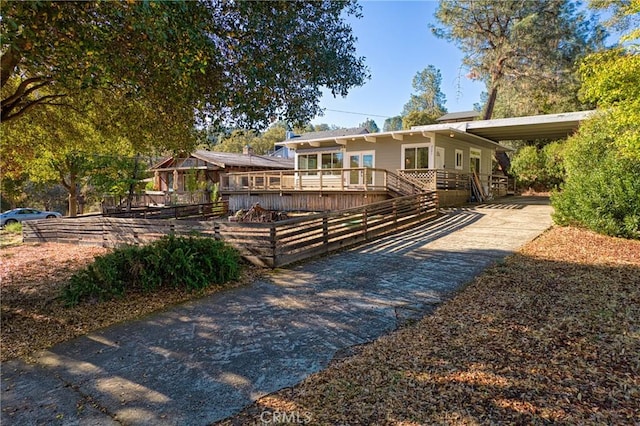 view of front of home with a carport and a wooden deck