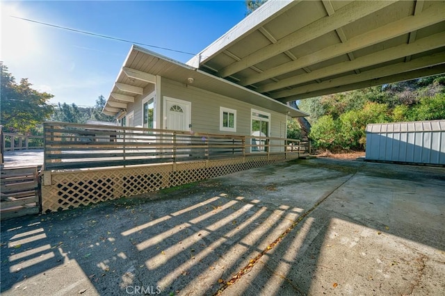 view of side of home with a wooden deck