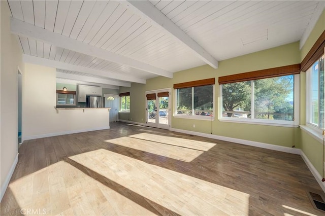 unfurnished sunroom featuring beamed ceiling and wooden ceiling