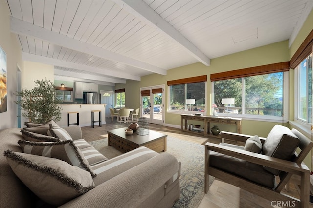 sunroom / solarium featuring beam ceiling and wood ceiling