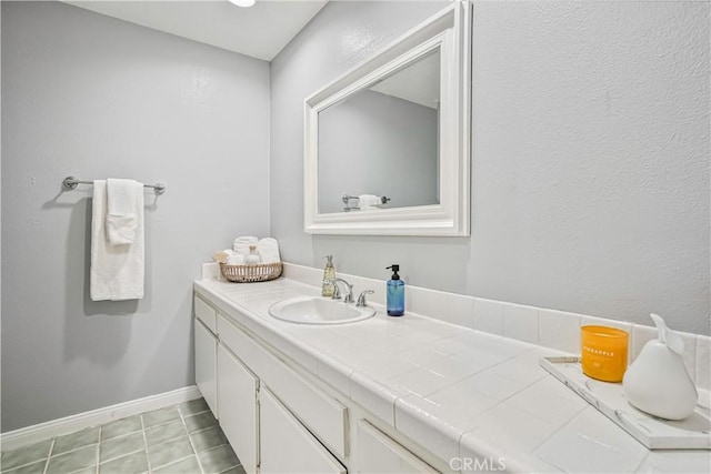 bathroom featuring tile patterned flooring and vanity