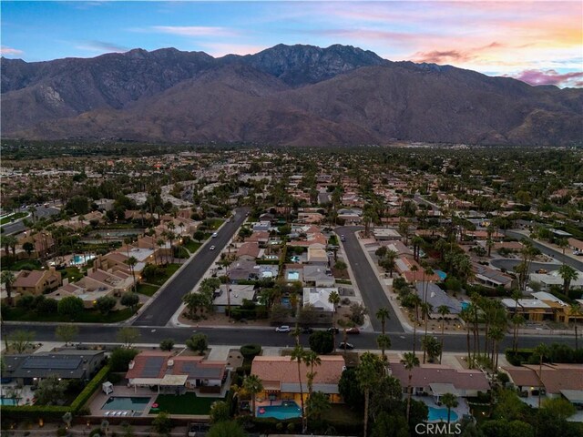 aerial view at dusk featuring a mountain view