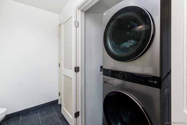 washroom with stacked washer and dryer