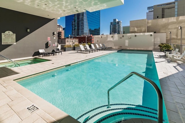 view of pool featuring a patio area and a community hot tub