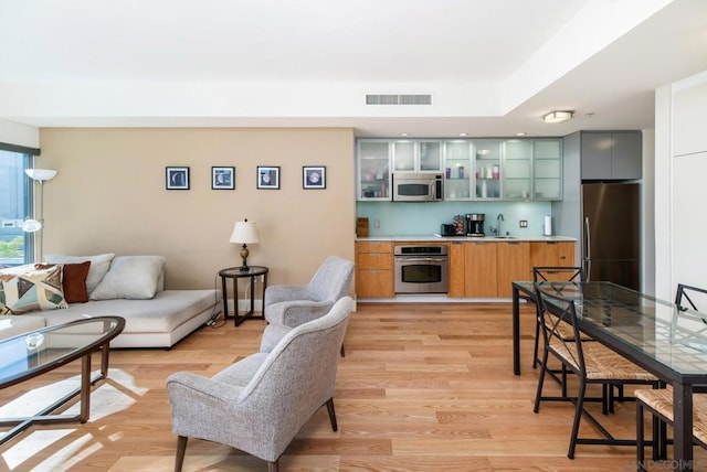 living room featuring light hardwood / wood-style flooring and sink