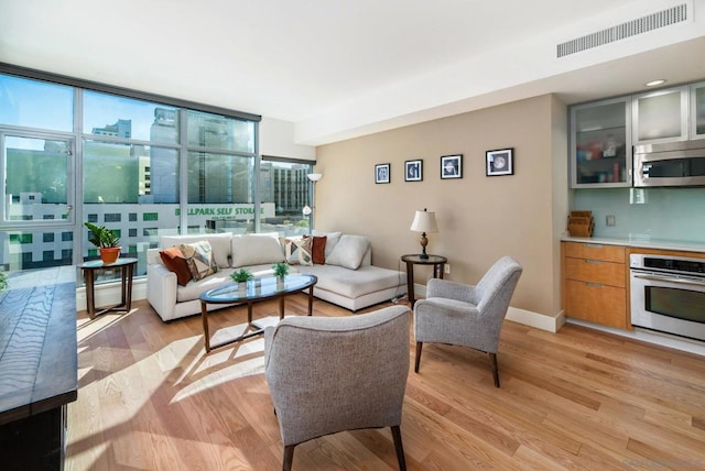 living room with light hardwood / wood-style flooring and expansive windows