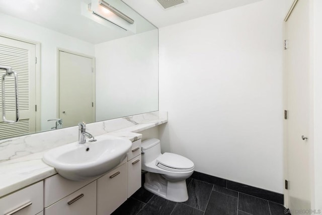 bathroom featuring vanity and toilet