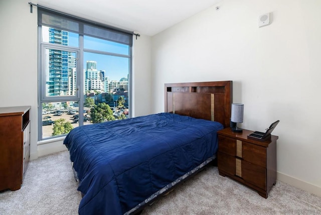 carpeted bedroom featuring multiple windows