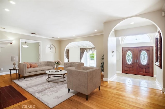 living room with light hardwood / wood-style floors and ornamental molding