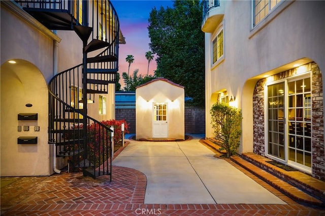 view of patio terrace at dusk