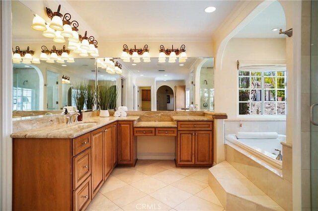 bathroom featuring tile patterned flooring, vanity, a relaxing tiled tub, and ornamental molding