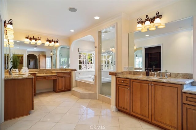 bathroom featuring tile patterned floors, vanity, crown molding, and tiled bath