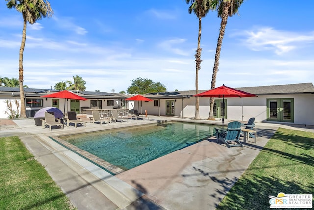 view of pool with a patio area and french doors