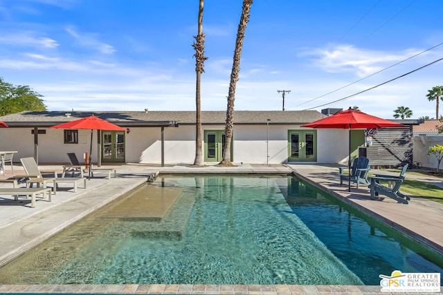 view of pool featuring french doors and a patio