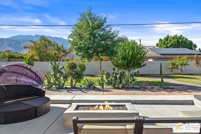 view of patio / terrace featuring a mountain view and a fire pit