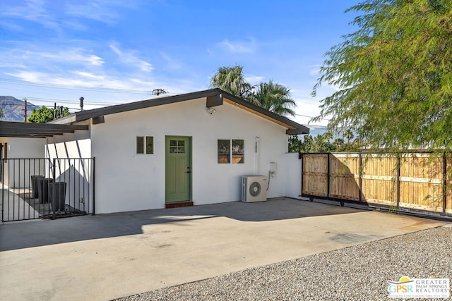 rear view of house featuring washer / dryer and a patio