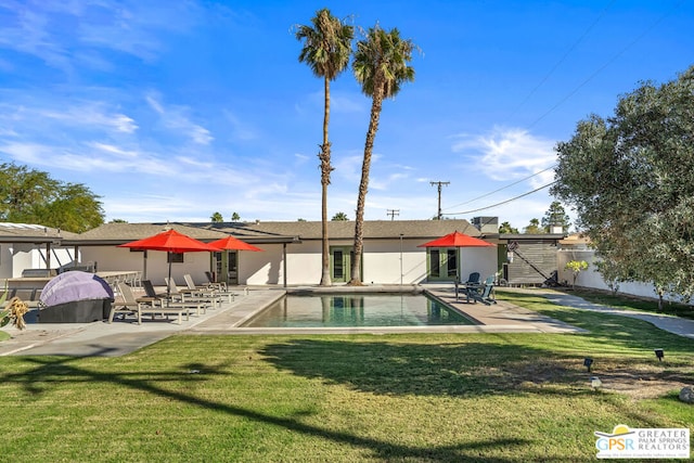 view of swimming pool with a patio area and a lawn