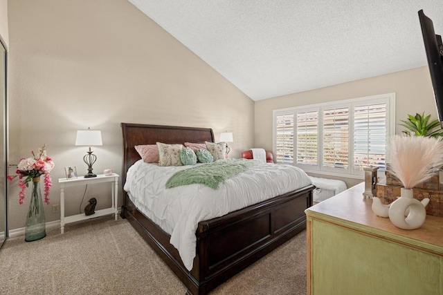 carpeted bedroom featuring a textured ceiling and high vaulted ceiling