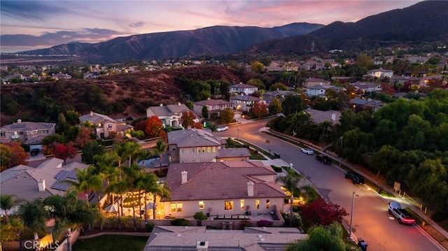 aerial view at dusk featuring a mountain view