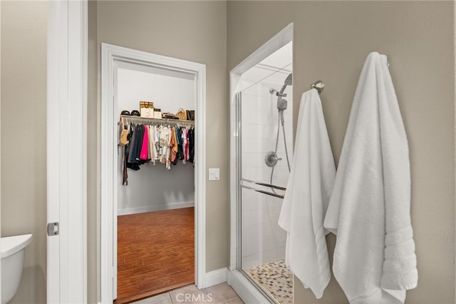 bathroom featuring wood-type flooring and a shower with door