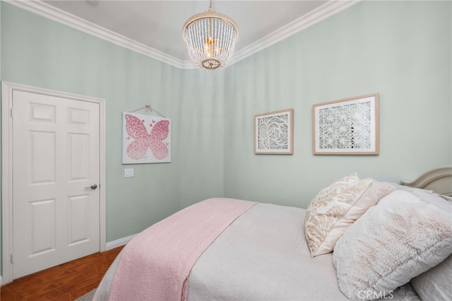 bedroom featuring hardwood / wood-style flooring, a notable chandelier, and ornamental molding