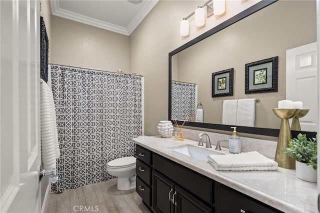 bathroom featuring walk in shower, wood-type flooring, toilet, vanity, and ornamental molding