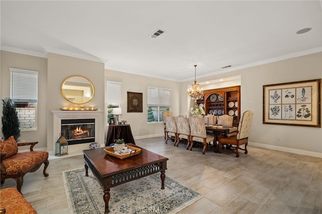 living room featuring an inviting chandelier and crown molding