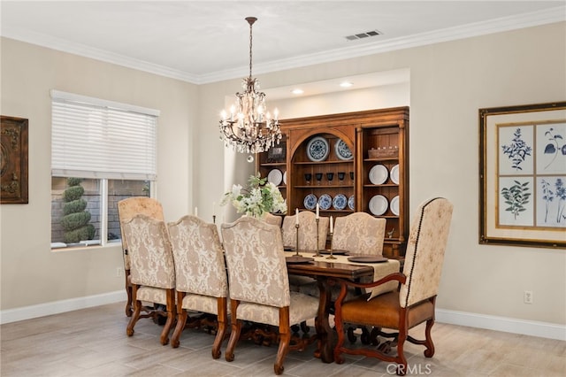 dining area with light hardwood / wood-style flooring, crown molding, and an inviting chandelier