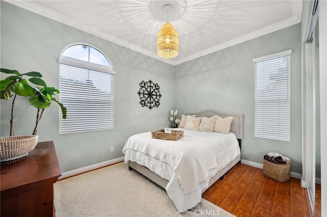 bedroom featuring crown molding and hardwood / wood-style flooring