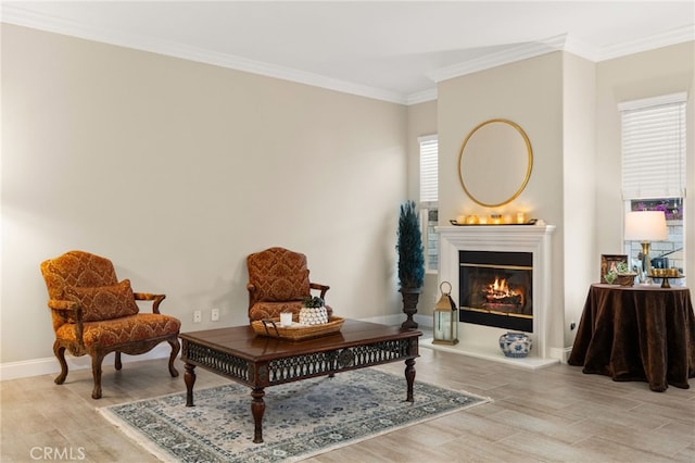 living area featuring crown molding and light hardwood / wood-style flooring