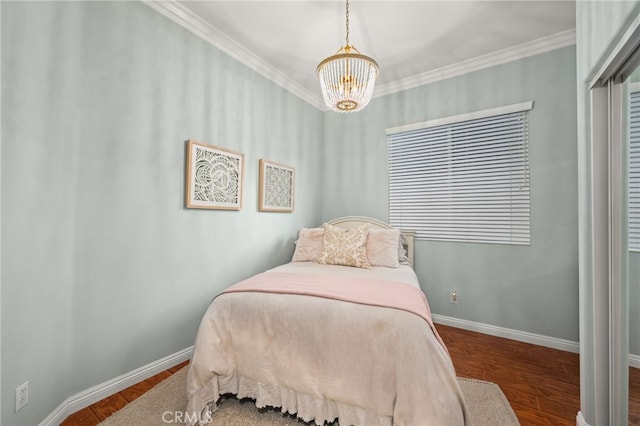 bedroom with crown molding, hardwood / wood-style floors, and a chandelier