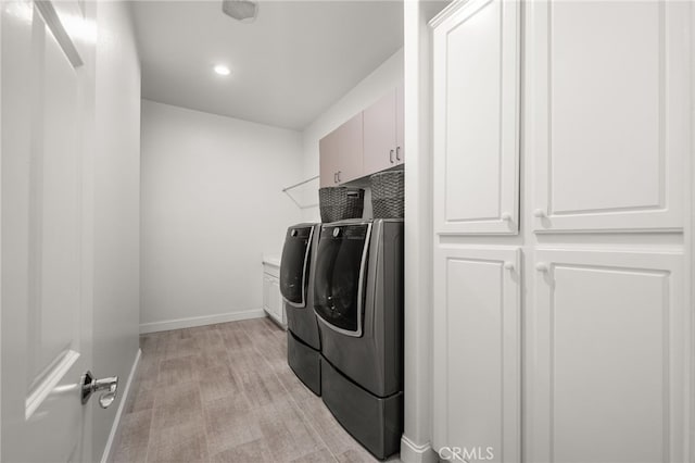 laundry area featuring cabinets and independent washer and dryer