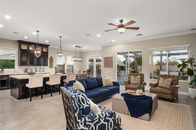 living room featuring ceiling fan, light hardwood / wood-style floors, and ornamental molding