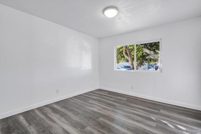 empty room with dark wood-type flooring