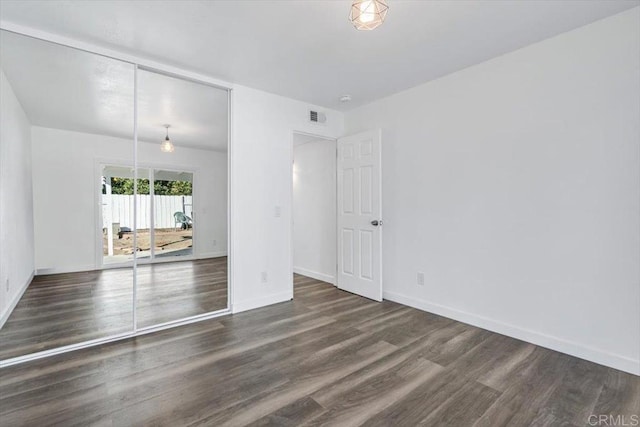 empty room featuring dark hardwood / wood-style flooring