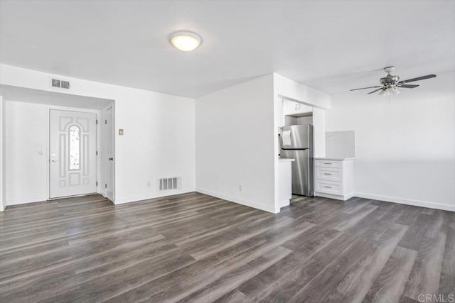 unfurnished living room with ceiling fan and dark wood-type flooring