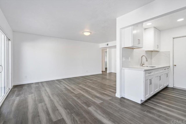 kitchen with white cabinetry, sink, and dark wood-type flooring