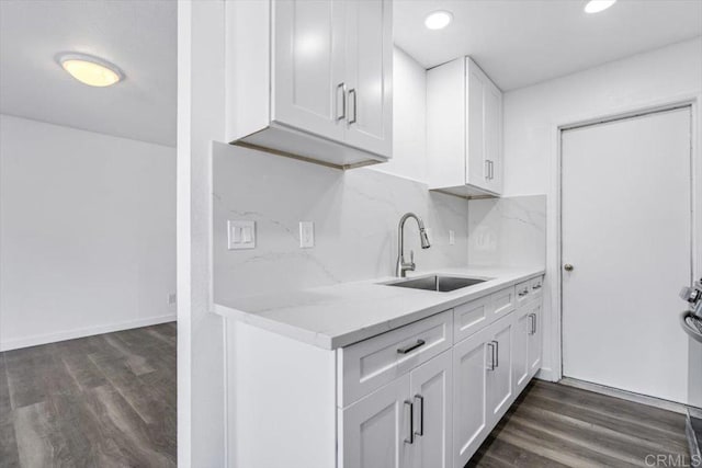 kitchen with white cabinets, dark hardwood / wood-style flooring, and sink