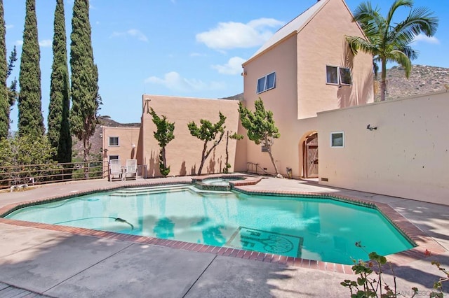 view of swimming pool featuring an in ground hot tub and a patio area