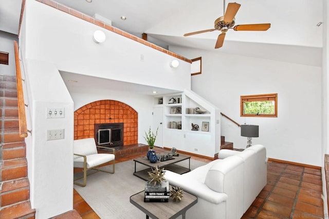 tiled living room with built in shelves, ceiling fan, and vaulted ceiling