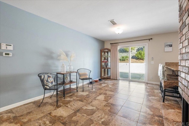 living area with a brick fireplace