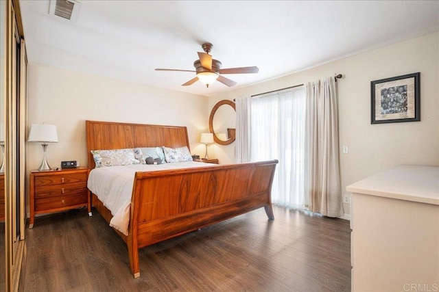 bedroom with ceiling fan and dark wood-type flooring