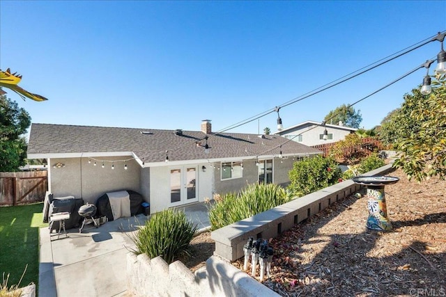 back of house featuring a patio and french doors