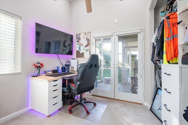 carpeted office space featuring french doors and plenty of natural light