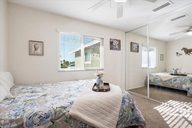 carpeted bedroom with a closet and ceiling fan