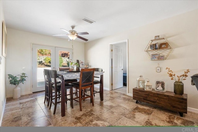 dining room featuring ceiling fan and french doors