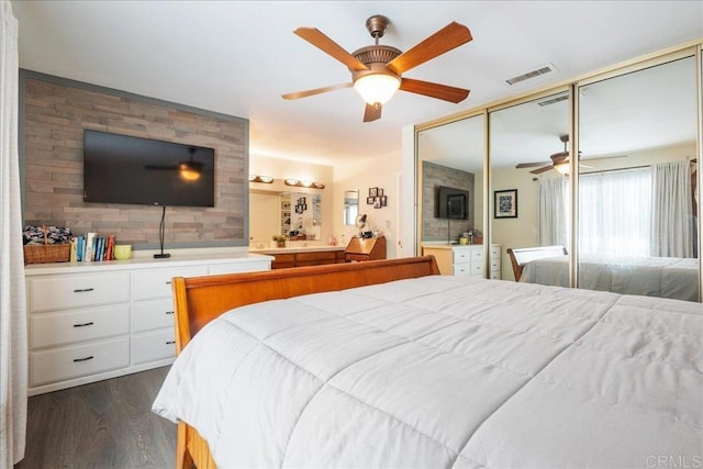 bedroom with a closet, dark hardwood / wood-style floors, and ceiling fan